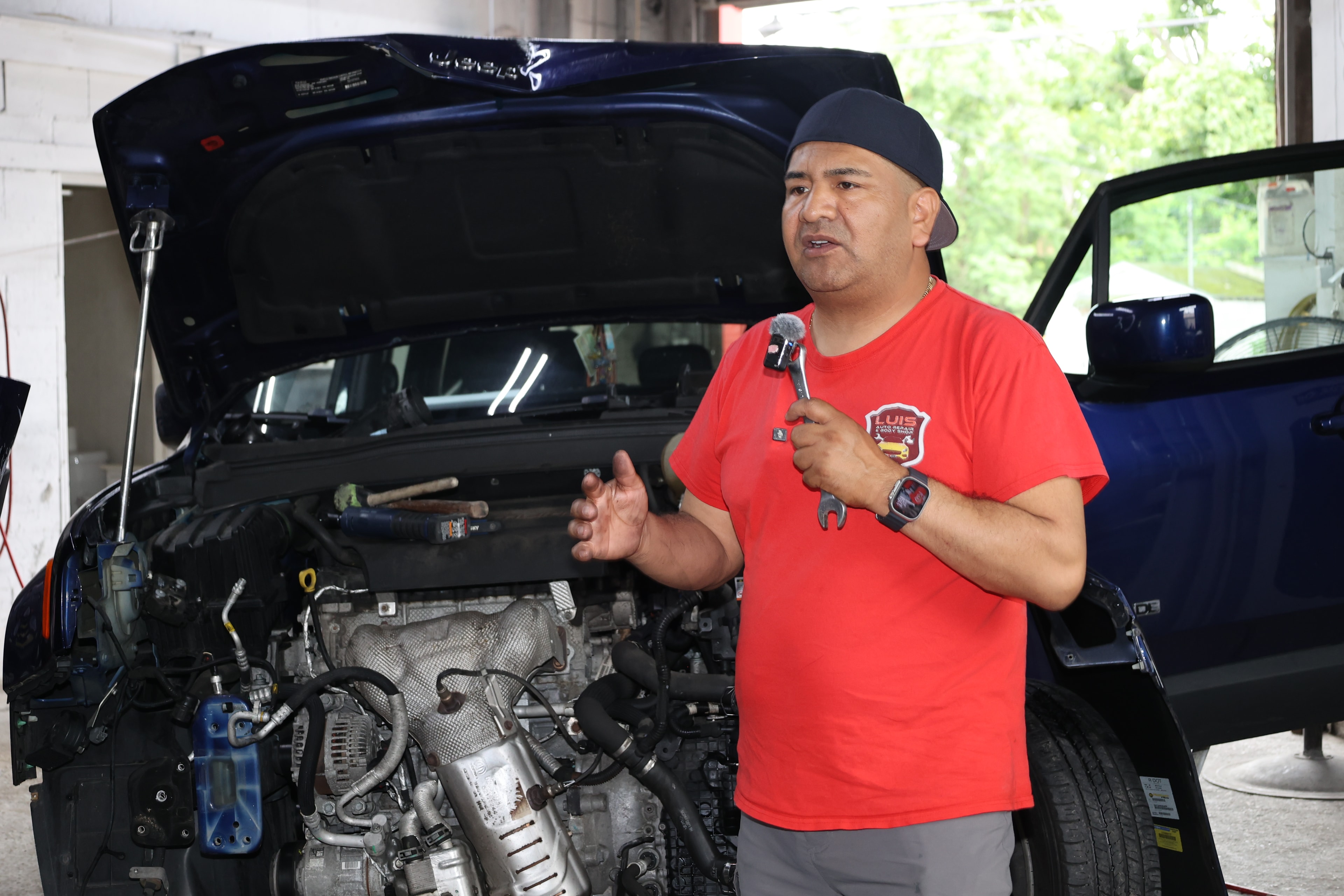 Auto technician reviewing vehicle diagnostics on a tablet